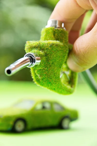 Hand holding eco fuel nozzle — Stock Photo, Image