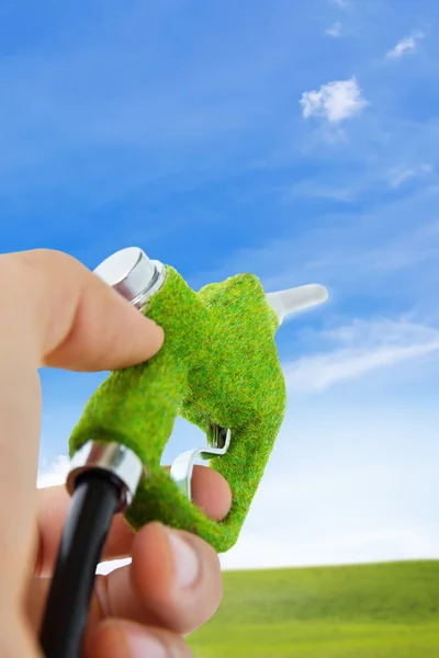 Hand holding eco fuel nozzle — Stock Photo, Image