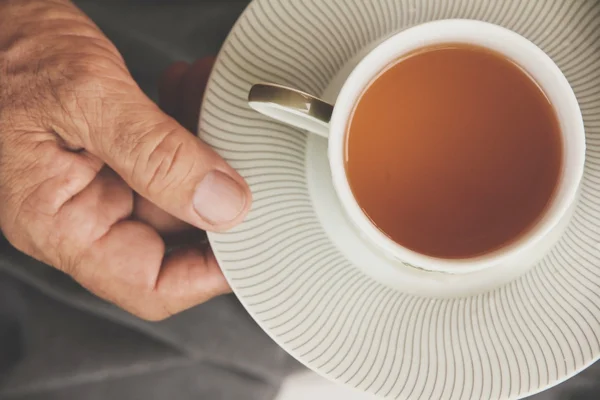 Eine Hand gießt eine Tasse Tee — Stockfoto