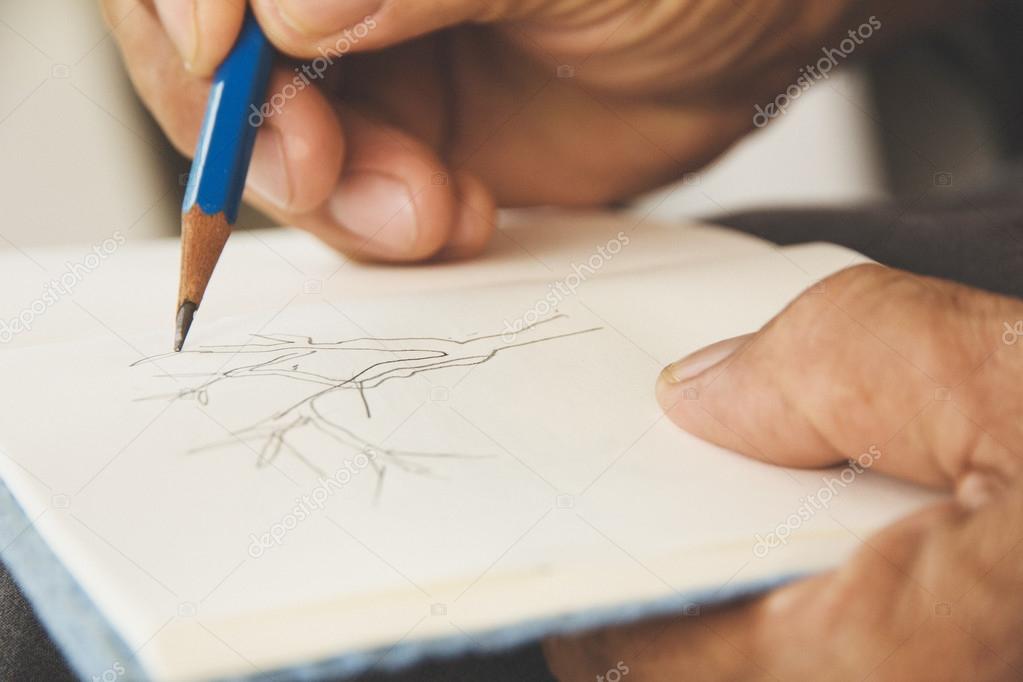 Man writing on sketchbook