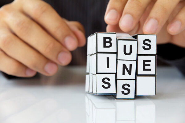 Business man hand holding a cube,business concept