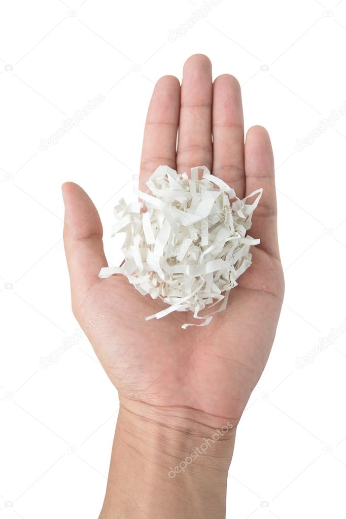 Hand holding shredded paper isolated on white background