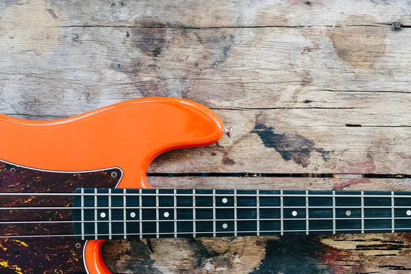 Orange Electric Bass Guitar Wood Background Copy Space — Stock Photo, Image