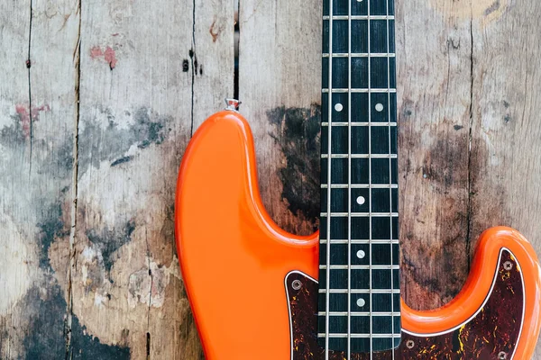 Orange Electric Bass Guitar Wood Background Copy Space — Stock Photo, Image