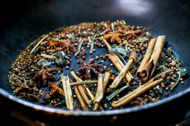 spices in a pan, A spice is a seed, fruit, root, bark, or other plant substance primarily used for flavoring or coloring food. Spices are sometimes used in medicine, cosmetics or perfume production