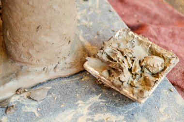 clay on wooden table in workshop