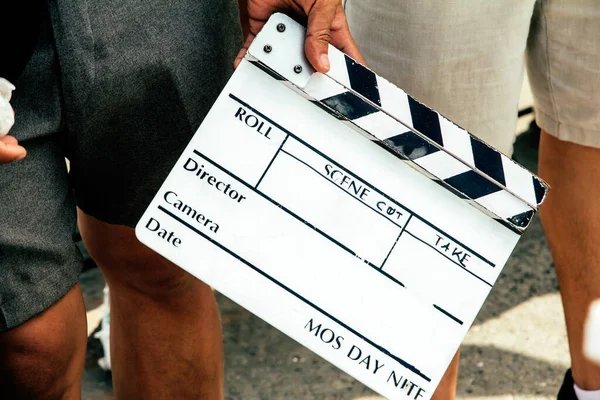 close up image of film production crew holding Film Slate on set