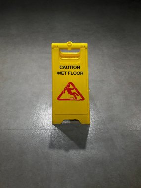Uyarı işareti beton zeminde temiz sarıdır.