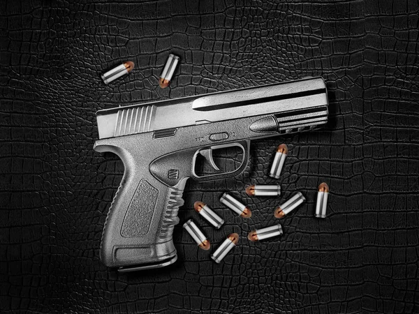 Gun Silver Metal Bullets Black Leather Background — Stok fotoğraf