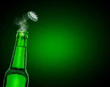 cold wet open beer bottle with smoke on green background