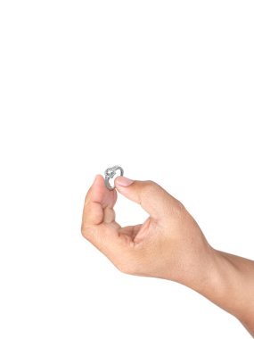 Hand holding diamond ring isolated on white background