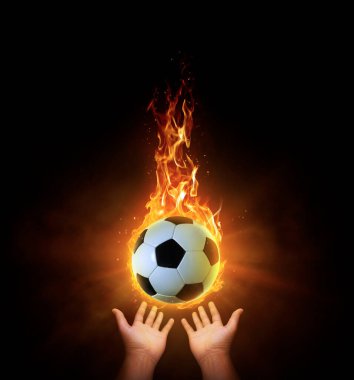 Futbol topu. Siyah arka plan dumanlı, sarı turuncu kırmızı beyaz arka ışık