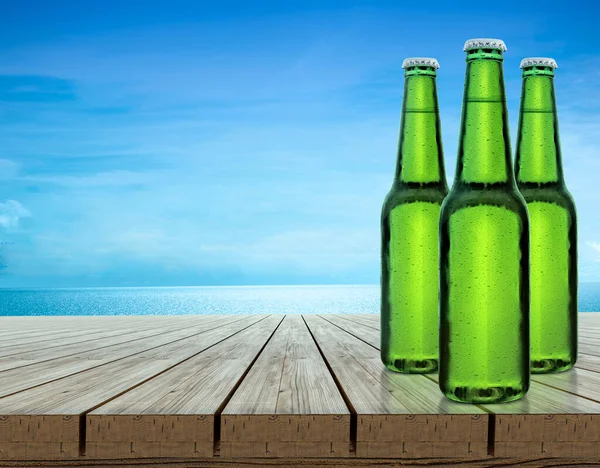 Beer Bottle Water Drops Indigo Wood Table Top Blue Background — Stock fotografie