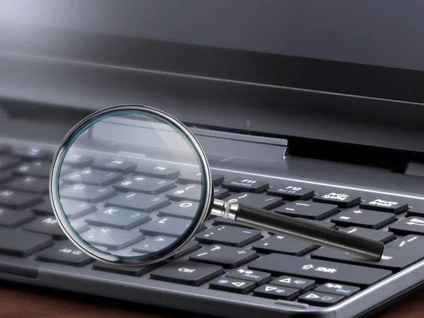 laptop computer with magnifying glass search concept