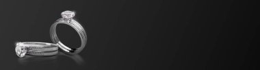 Elegant diamond ring on black background, wide image. 3d render