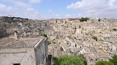 Matera 'nın taşları: tarihi köydeki Piazza Vittorio istikametindeki pan görüntüleri. Tuff blokları ile inşa edilmiş evlerle şehir manzarası ve onların kaotik düzenleri büyüleyici..