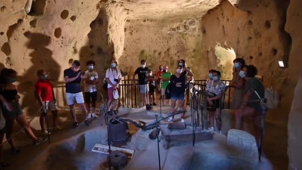 意大利Basilicata的Matera 2021年8月导游在一座用凝灰岩雕成的老房子里给游客们讲解导游游览的镜头 — 图库视频影像