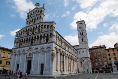 Lucca, Toskana, İtalya. Ağustos 2020. Foro 'daki San Michele Kilisesi' nin muhteşem manzarası. Geniş format panoramik fotoğraf. Güzel güneşli bir gün, meydandaki insanlar.