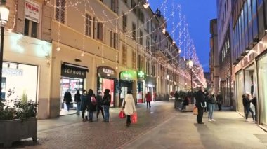 Parma, Emilia-Romagna, Italy. January 2022. Incredible POV footage along downtown street with Christmas lights. People with masks to defend themselves from the coronavirus.