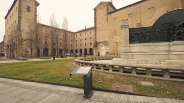 Parma, Emilia-Romagna, Italy. January 2022. Tilt footage with the view of the Palazzo della Pilotta, on the right the monument to the composer Giuseppe Verdi