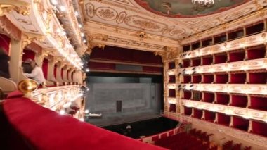 Parma,Emilia-Romagna,Italy.January 2022. Amazing pan footage inside the Teatro Regio the wide-angle view makes you appreciate the breadth and harmony of the structure and the finely decorated ceiling.