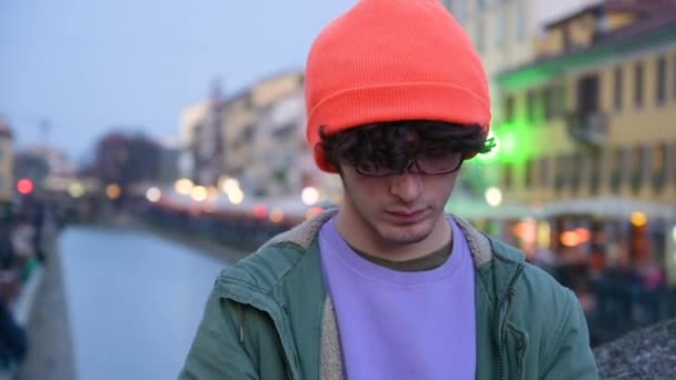 Cute Young Caucasian Man Wearing Glasses Orange Cap Using His — стоковое видео