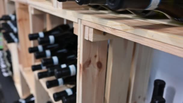 Close Footage Light Wooden Shelf Numerous Wine Bottles Lying Conceptual — ストック動画