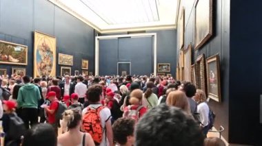 Paris, France, June 2022. POV footage of the person entering the exhibition hall of Leonardo's Gioconda. Walk through the queue to see the famous portrait.