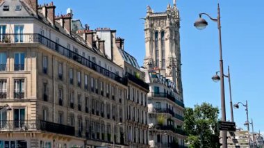 Paris, France, June 2022. Beautiful tilt footage of the Tour Saint-Jacques, the only evidence of a church demolished during the French Revolution. The numerous statues that decorate it are striking.