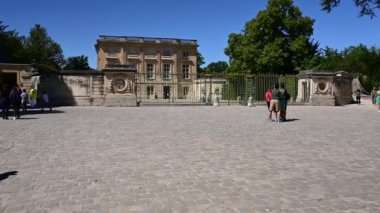 Versailles, Paris, France, June 2022. POV footage of the tourist walking towards the entrance to the Petit Trianon. Pass by other people.