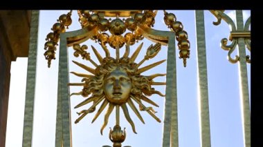 Versailles, Paris, France, June 2022. Detail of the gate of the palace: the golden representation of the king's face expresses all the beauty and splendor of the palace, a symbol of power.