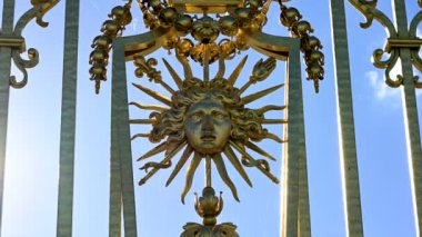 Versailles, Paris, France, June 2022. Detail of the gate of the palace: the golden representation of the king's face expresses all the beauty and splendor of the palace, a symbol of power.