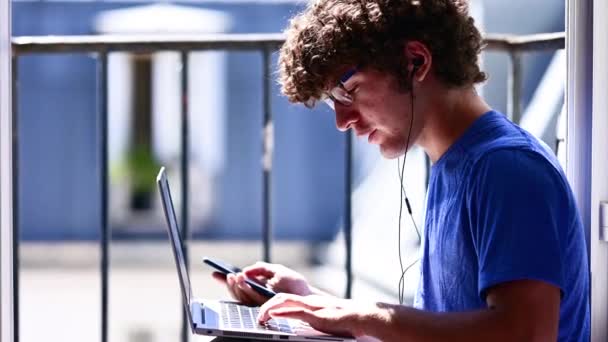 Portrait Young Caucasian Man Window Working Laptop While Talking Cellphone — Stock Video