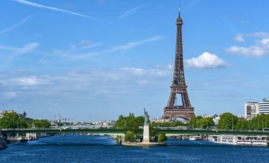 Paris,France.June 2022.Amazing shot that collects two symbols of France: the Eifell tower and the statue of liberty at the base.An iconic image of the city on a beautiful summer day