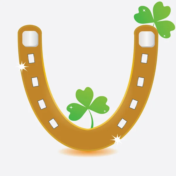 Horseshoe and four leaf clover. — Stockvector