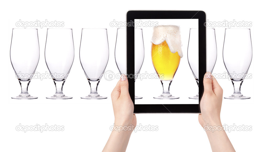 Empty and one full beer on tablet computer screen