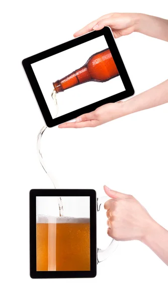 Digital tablet with fresh beer pouring down from a bottle — Stock Photo, Image