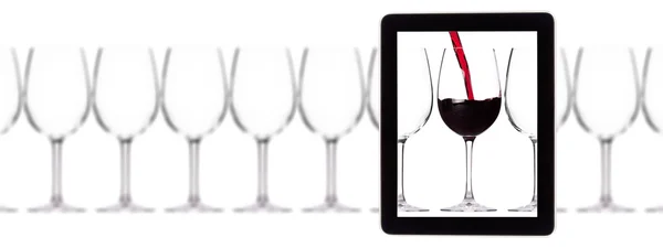 Glass of red wine on tablet computer screen — Stock Photo, Image