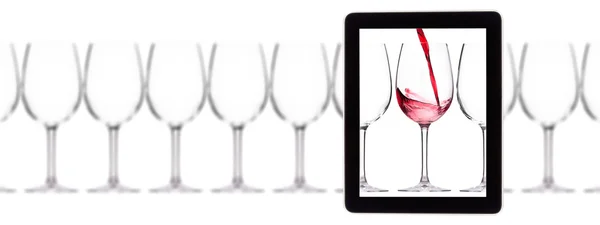 Glass of red wine on tablet computer screen — Stock Photo, Image