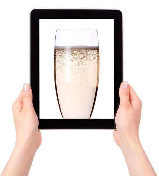 Glass of champagne flutes on a tablet screen — Stock Photo, Image