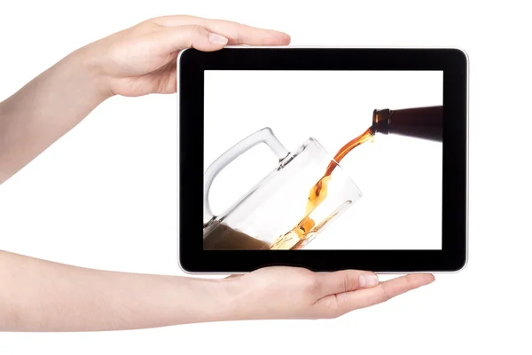 Beer pouring from bottle in to the glass on a tablet screen — Stock Photo, Image