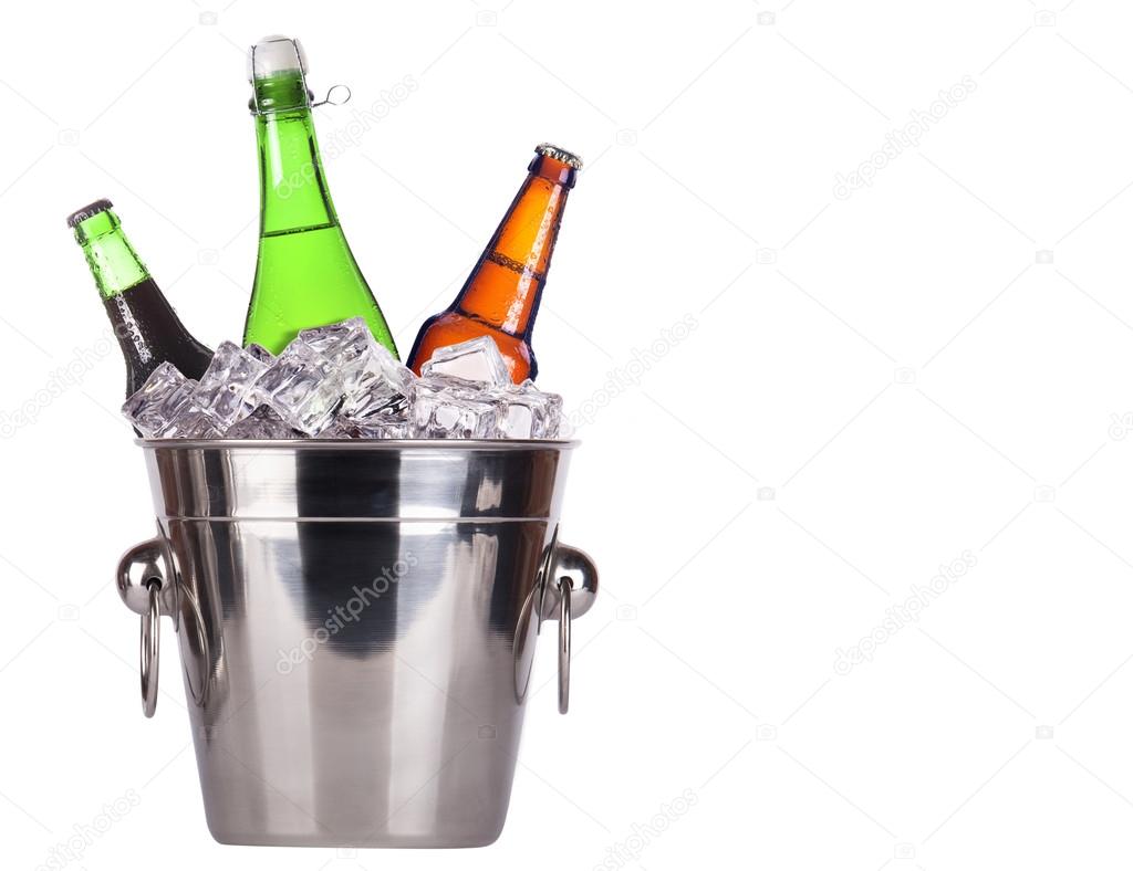 Champagne bottle in ice bucket and beer