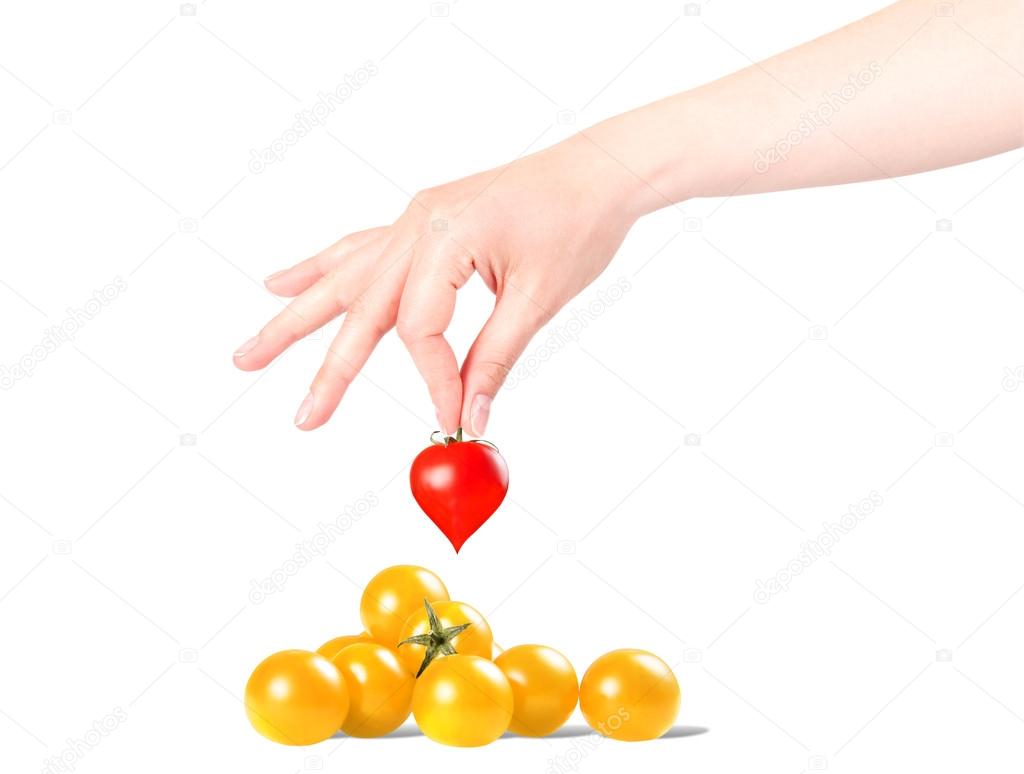 Heart background with hand and sherry tomatoes