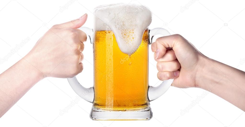 Competition of two human hands with beer in glass