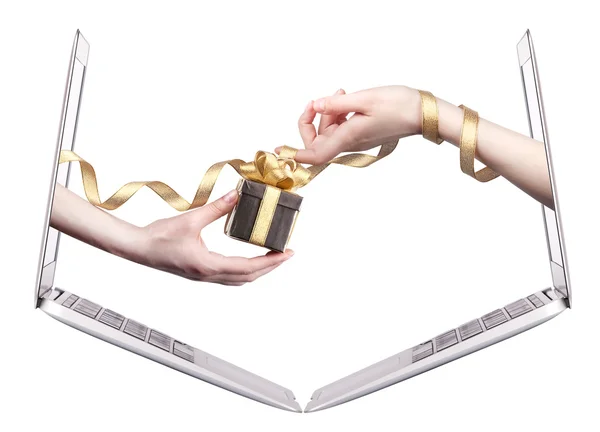 Hand with a gift and laptop — Stock Photo, Image