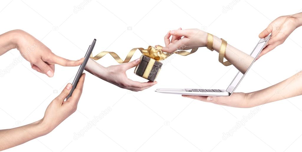 hand with a gift and laptop