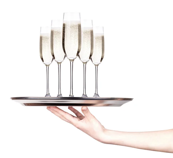 Glas champagne på en silverbricka — Stockfoto