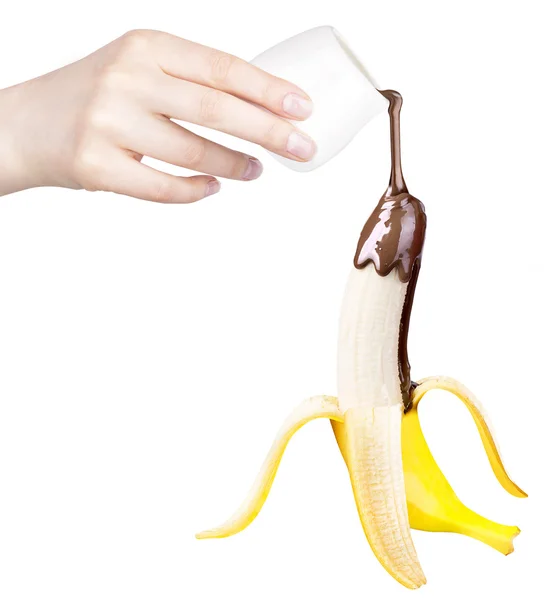 Banana com chocolate e mão — Fotografia de Stock