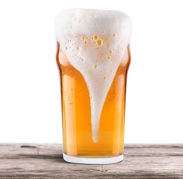 Frosty fresh beer with foam isolated on wooden table — Stock Photo, Image