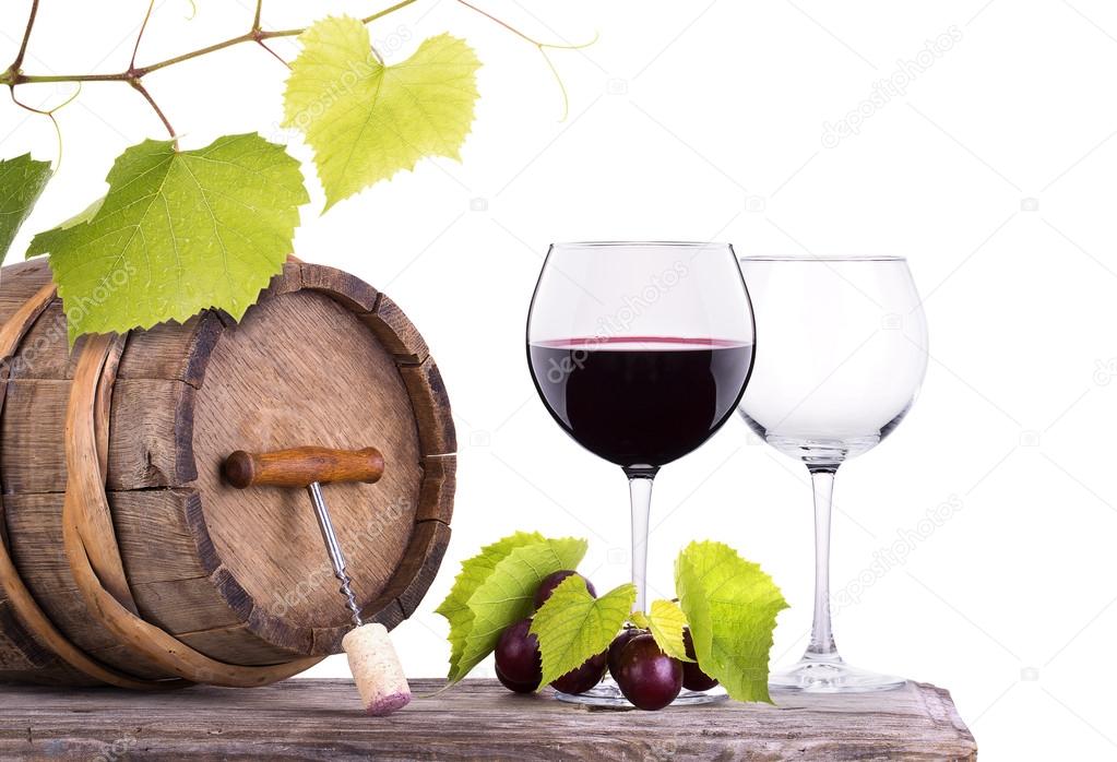 Red wine, glass and barrel with grapes